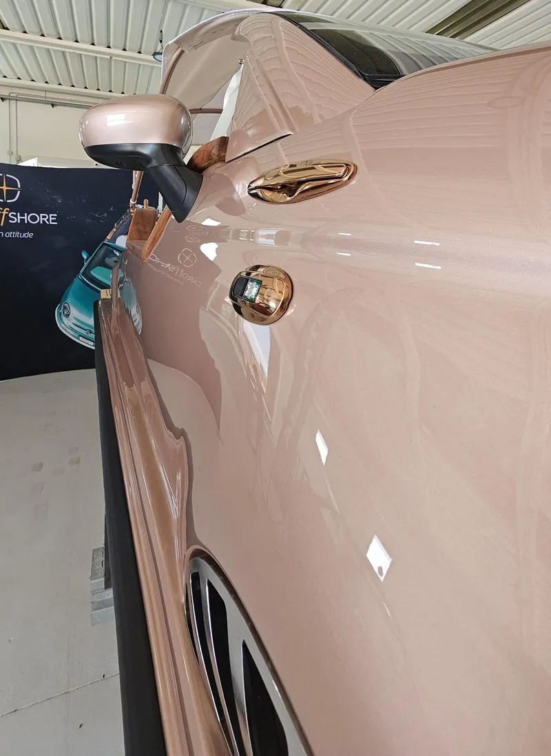Slide: The Image of 2026 Car Off-shore Fiat 500 in rose gold, showcasing sleek design and luxurious finish. - 13