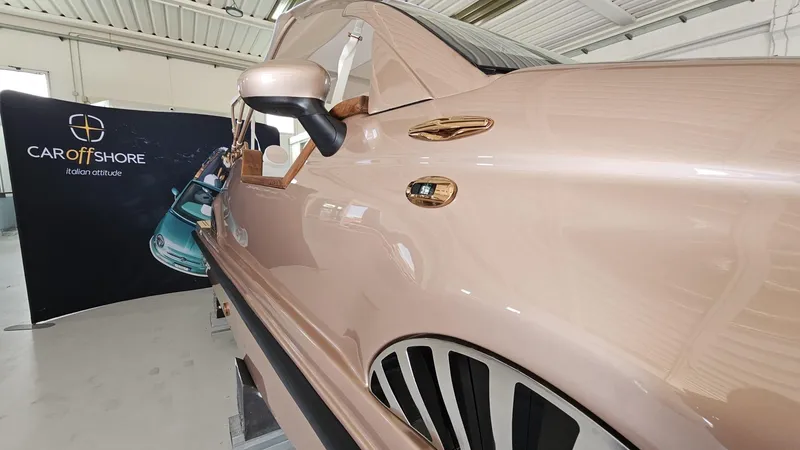 Slide: The Image of 2026 Car Off-shore Fiat 500 in rose gold, showcased indoors with branding backdrop. - 17