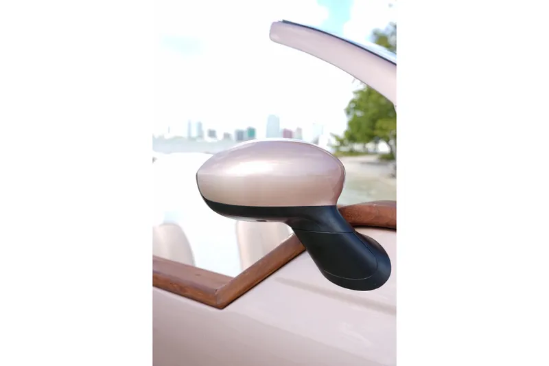 Slide: The Image of Side mirror of 2026 Car Off-shore Fiat 500 Rose Gold, scenic background. - 19