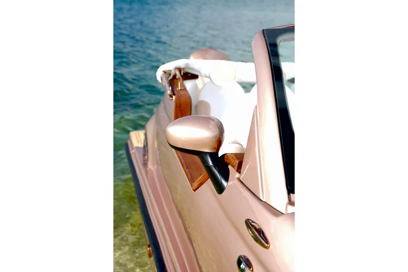 Slide: The Image of Rose gold Fiat 500 boat by Car Off-shore, 2026 model, on water. - 24