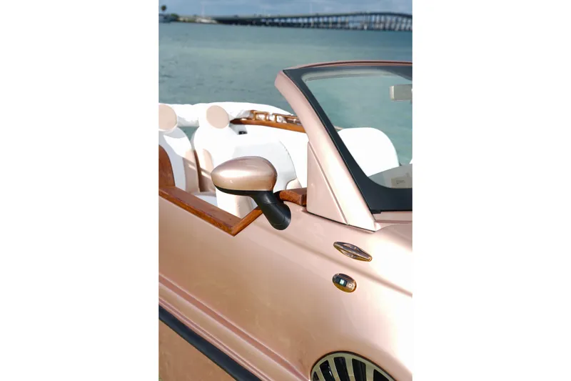 Slide: The Image of 2026 Car Off-shore Fiat 500 in rose gold by the sea, convertible design. - 25