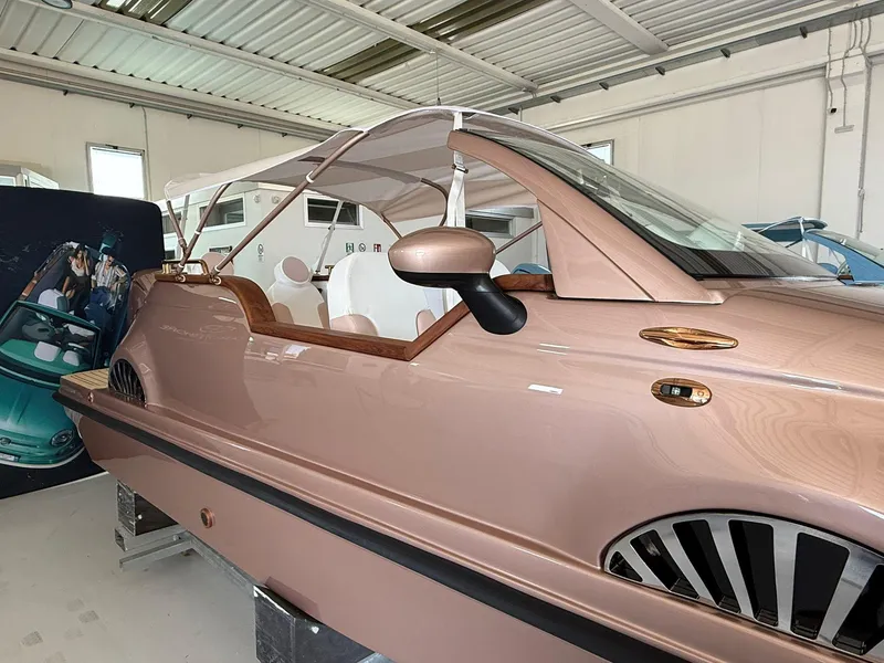 Slide: The Image of 2026 Car Off-shore Fiat 500 Rose Gold boat in a showroom, showcasing luxury design. - 6
