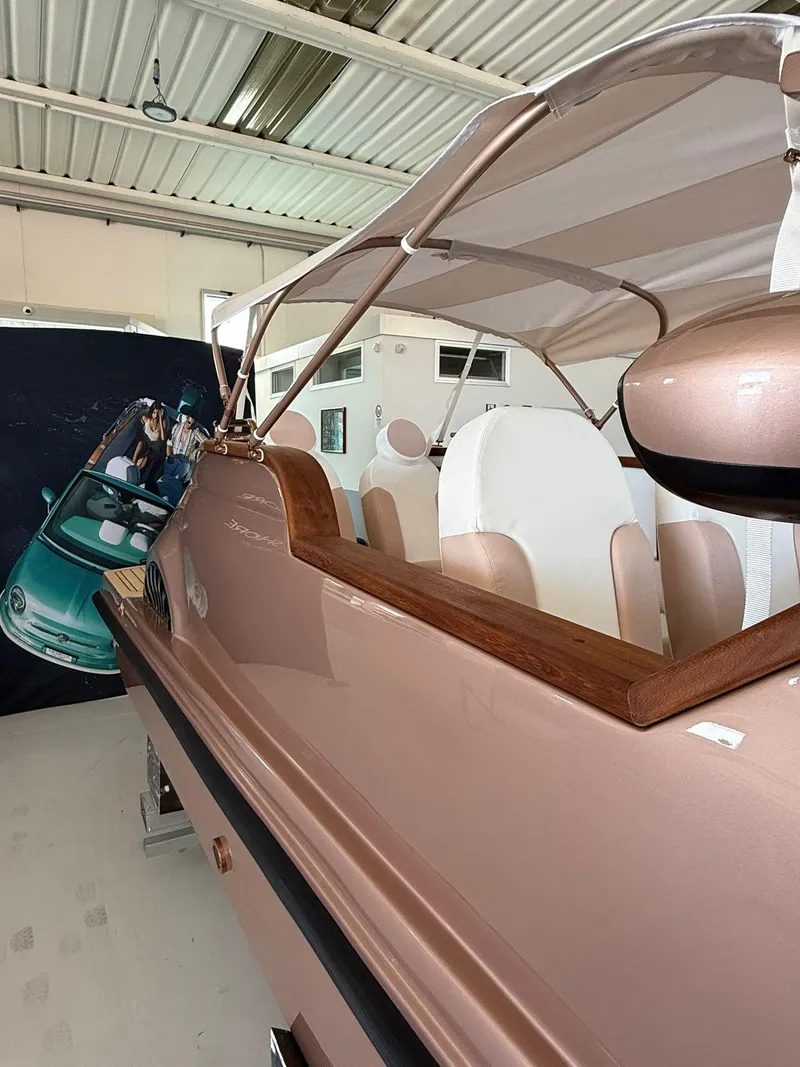 Slide: The Image of 2026 Car Off-shore Fiat 500 Rose Gold boat in a showroom, showcasing luxury design. - 8