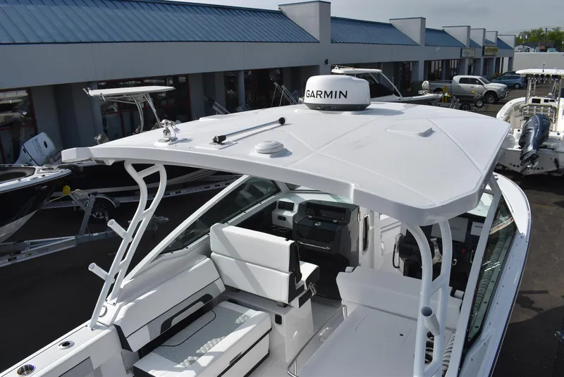 Slide: The Image of 2025 Blackfin 272 DC boat with Garmin equipment, docked at a marina. - 11