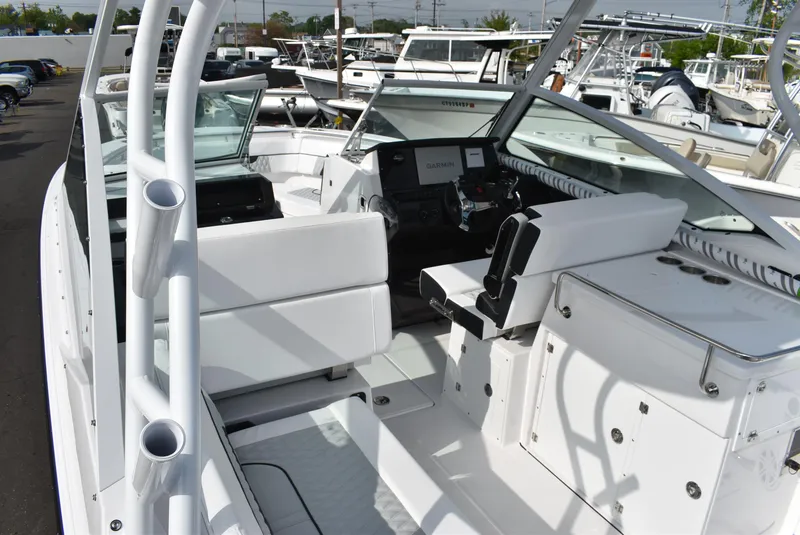 Slide: The Image of 2025 Blackfin 272 DC boat interior with white seating and modern dashboard. - 12