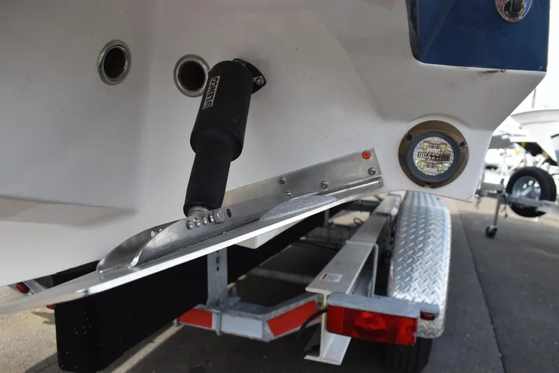 Slide: The Image of Rear view of a 2025 Blackfin 272 DC boat on a trailer, showing trim tab and LED light. - 14