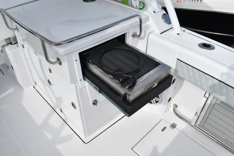 Slide: The Image of 2025 Blackfin 272 DC boat with built-in grill drawer open. - 16