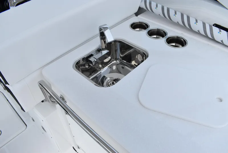Slide: The Image of 2025 Blackfin 272 DC boat sink and cup holders on deck. - 17