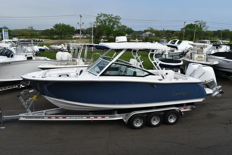 Slide: The Image of 2025 Blackfin 272 DC boat on trailer, displayed in a marina setting. - 3