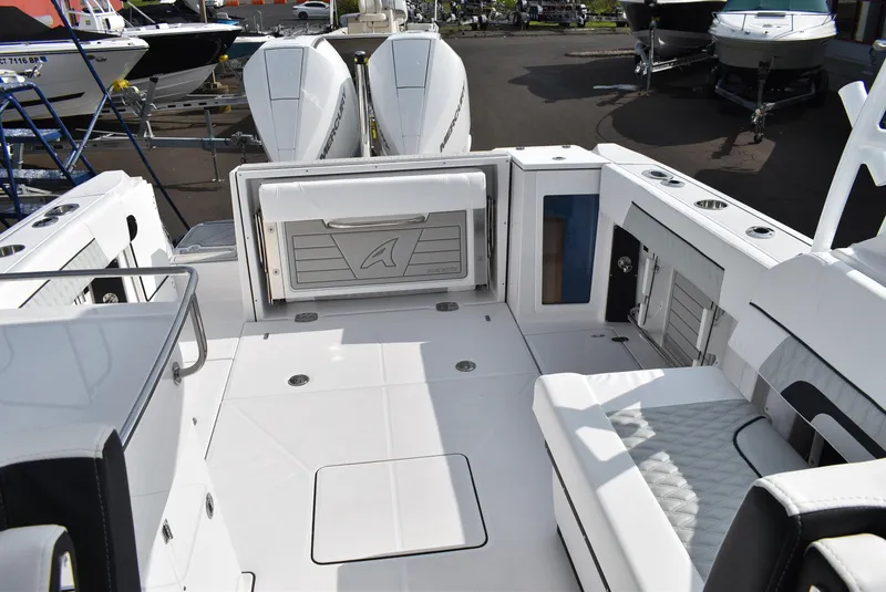 Slide: The Image of 2025 Blackfin 272 DC boat interior with seating and storage, featuring dual outboard engines. - 8