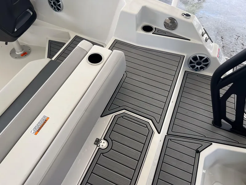Slide: The Image of 2026 Starcraft SVX 231 OB boat interior with gray decking and seating area. - 11