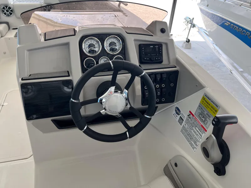 Slide: The Image of Steering console of 2026 Starcraft SVX 231 OB boat with gauges and controls. - 13