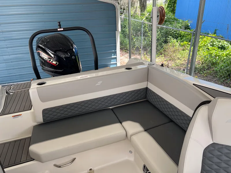 Slide: The Image of 2026 Starcraft SVX 231 OB boat interior with cushioned seating and outboard motor. - 15