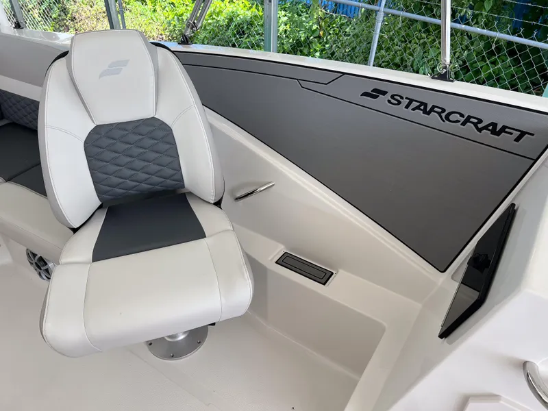 Slide: The Image of 2026 Starcraft SVX 231 OB boat interior with white and gray seating, sleek design. - 16