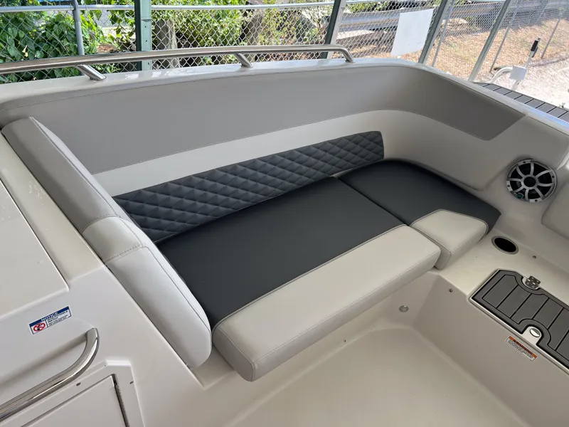 Slide: The Image of 2026 Starcraft SVX 231 OB boat interior with cushioned seating and speaker. - 24