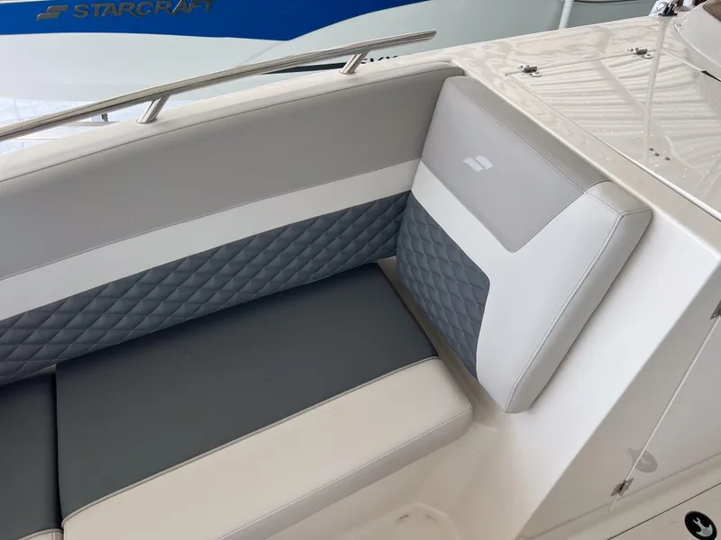 Slide: The Image of 2026 Starcraft SVX 231 OB boat interior with gray and white cushioned seating. - 26