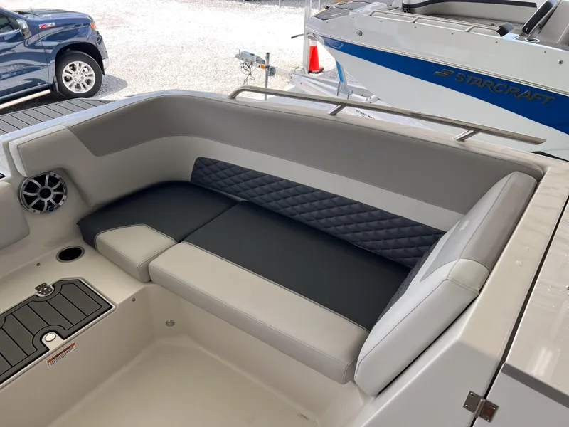Slide: The Image of 2026 Starcraft SVX 231 OB boat interior with cushioned seating and speaker. - 27