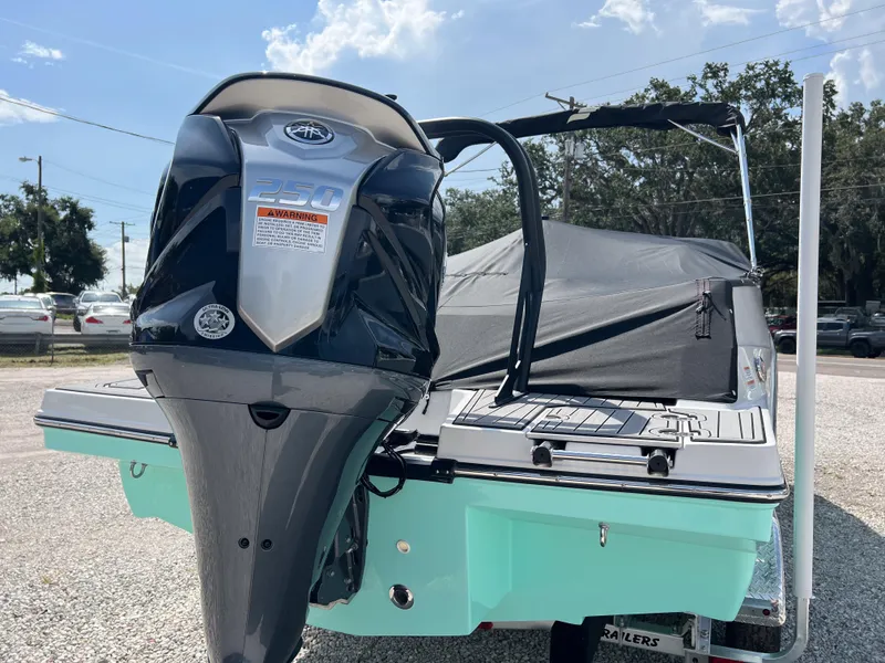 Slide: The Image of 2026 Starcraft SVX 231 OB boat with powerful outboard motor, parked on gravel. - 4