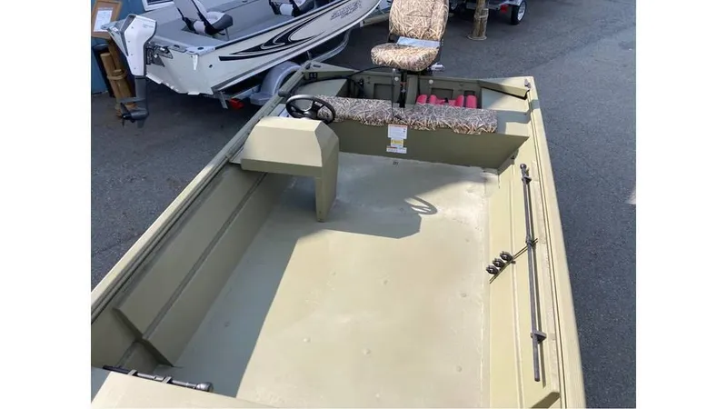 Slide: The Image of 2025 Lowe Roughneck RX1860 SC boat interior with camo seating, steering console, and spacious deck. - 4