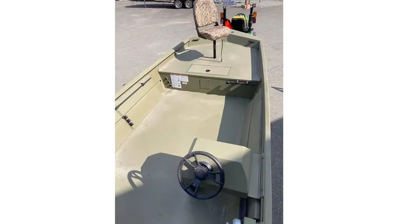 Slide: The Image of 2025 Lowe Roughneck RX1860 SC boat interior with steering wheel and camo seat. - 9