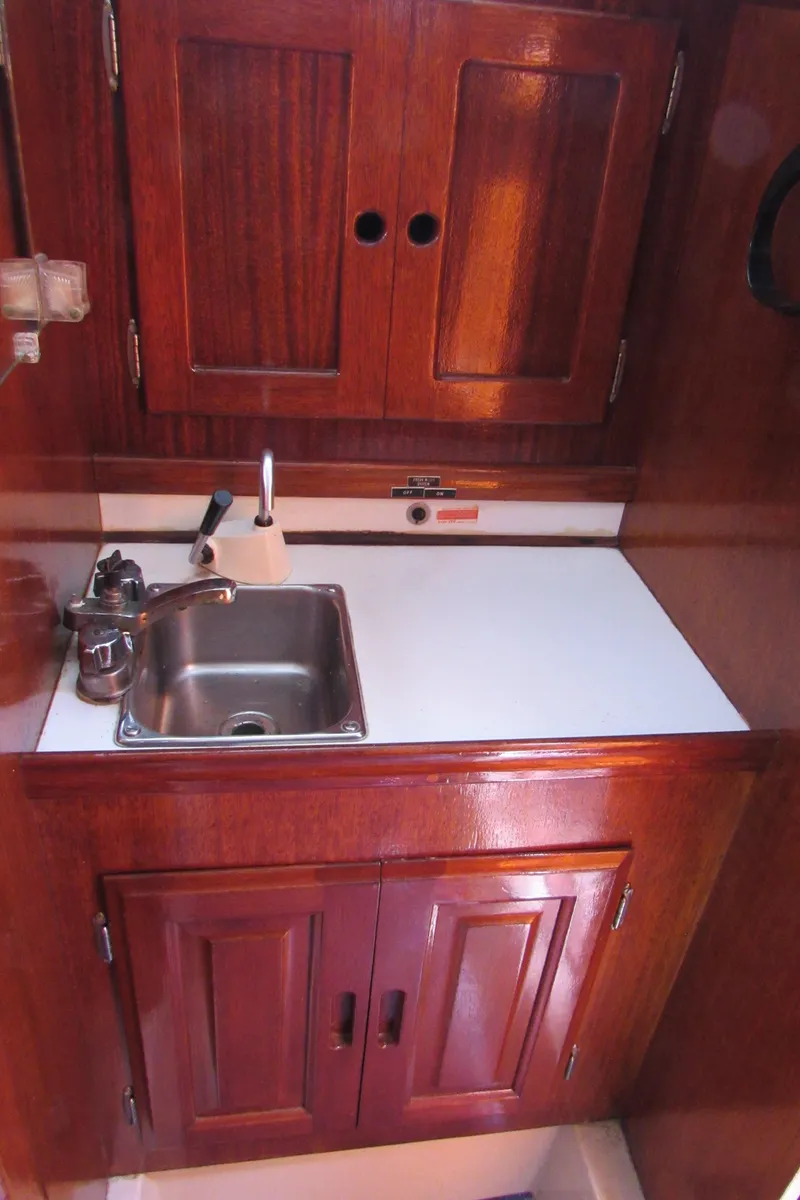Slide: The Image of Compact wooden boat galley with sink, cabinets, and countertop, CAL 34, 1968 model. - 10