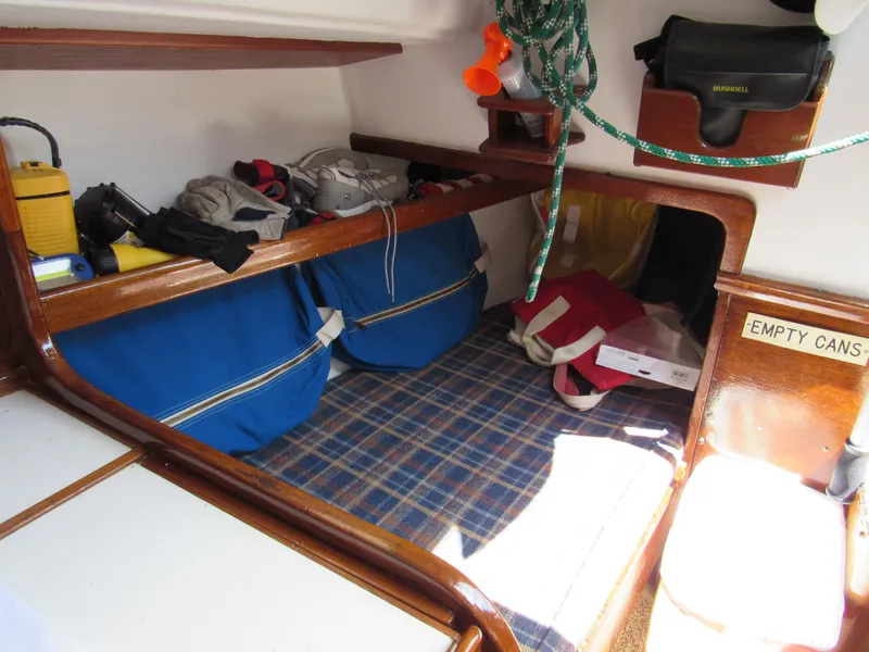 Slide: The Image of Interior of a 1968 CAL 34 sailboat with storage, bags, and nautical equipment. - 5