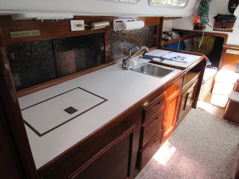 Slide: The Image of 1968 CAL 34 yacht interior with wooden cabinetry, sink, and countertop. - 6