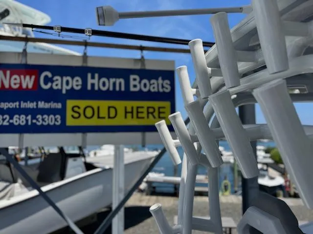 Slide: The Image of New Cape Horn Boats dealership sign with boat accessories in foreground, 2025 model available. - 24