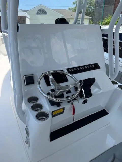 Slide: The Image of 2025 Cape Horn 34 T boat console with steering wheel and controls. - 12