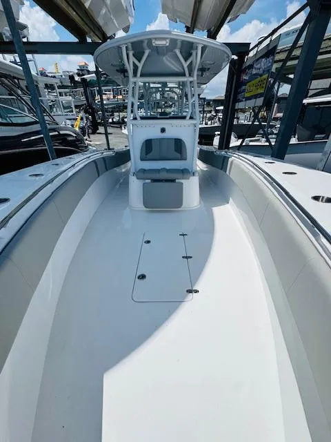 Slide: The Image of 2025 Cape Horn 34 T boat, sleek design, spacious deck, marina setting, clear sky. - 17