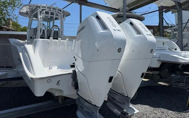 Slide: The Image of 2025 Cape Horn 34 T boat with dual Mercury V10 engines, docked in a marina. - 2