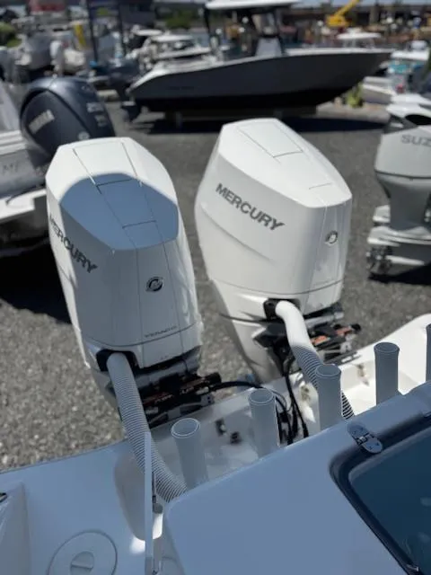 Slide: The Image of Twin Mercury outboard engines on a 2025 Cape Horn 34 T boat, docked in a marina. - 7