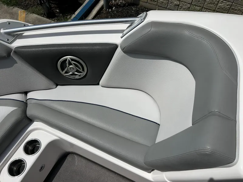 Slide: The Image of 2010 Supra Launch 21 V boat interior with gray seating and speaker detail. - 10