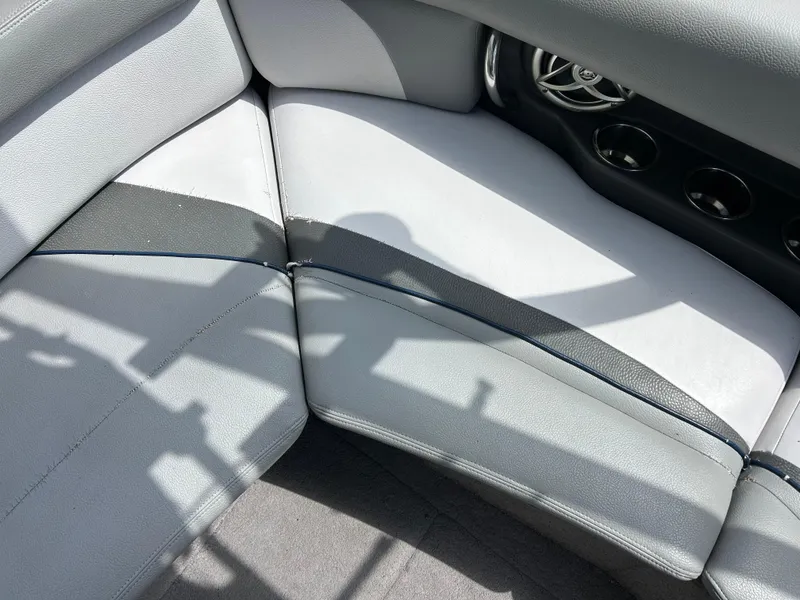 Slide: The Image of 2010 Supra Launch 21 V interior seating with gray upholstery and cup holders. - 14