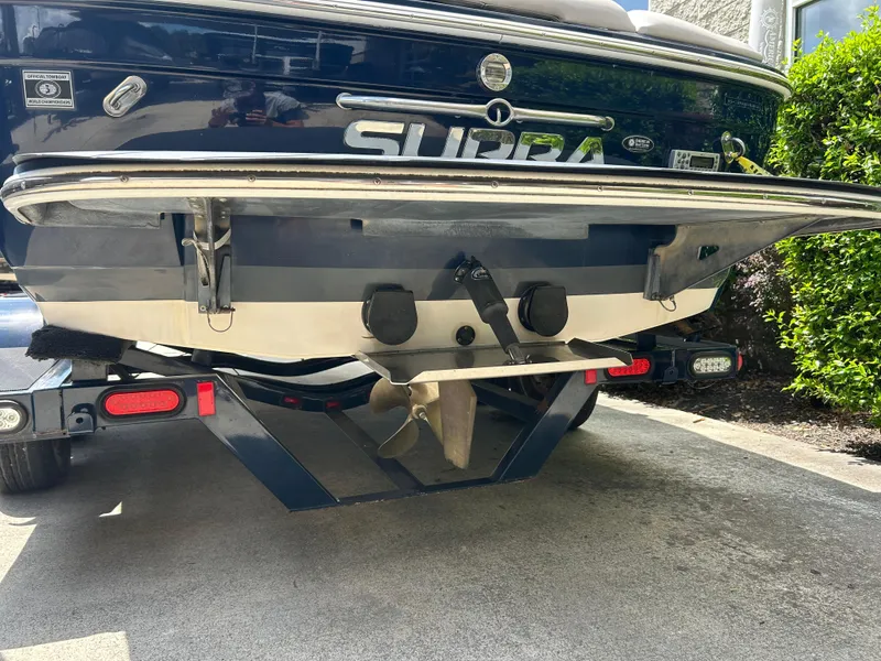 Slide: The Image of 2010 Supra Launch 21 V boat on trailer, rear view showing propeller and trim tabs. - 5