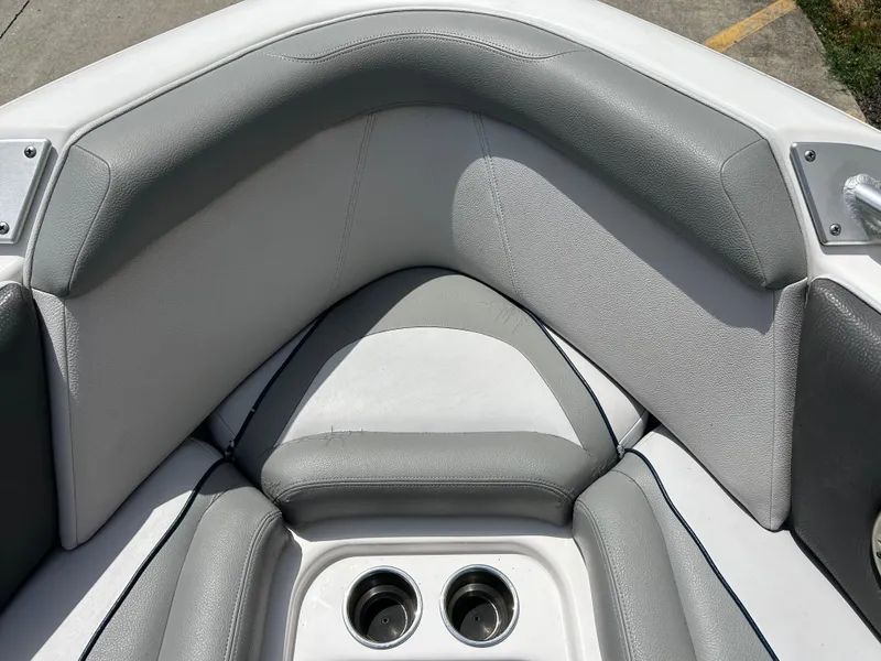 Slide: The Image of 2010 Supra Launch 21 V boat interior with gray seating and cup holders. - 7