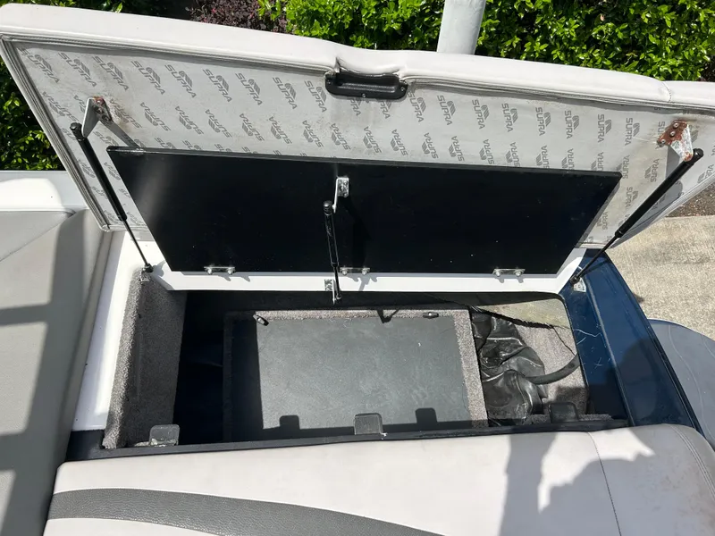 Slide: The Image of Open storage compartment in 2010 Supra Launch 21 V boat, showing interior details. - 9