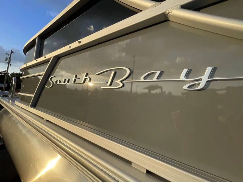 Slide: The Image of 2025 South Bay S224RS boat with sleek metallic finish in sunlight. - 11