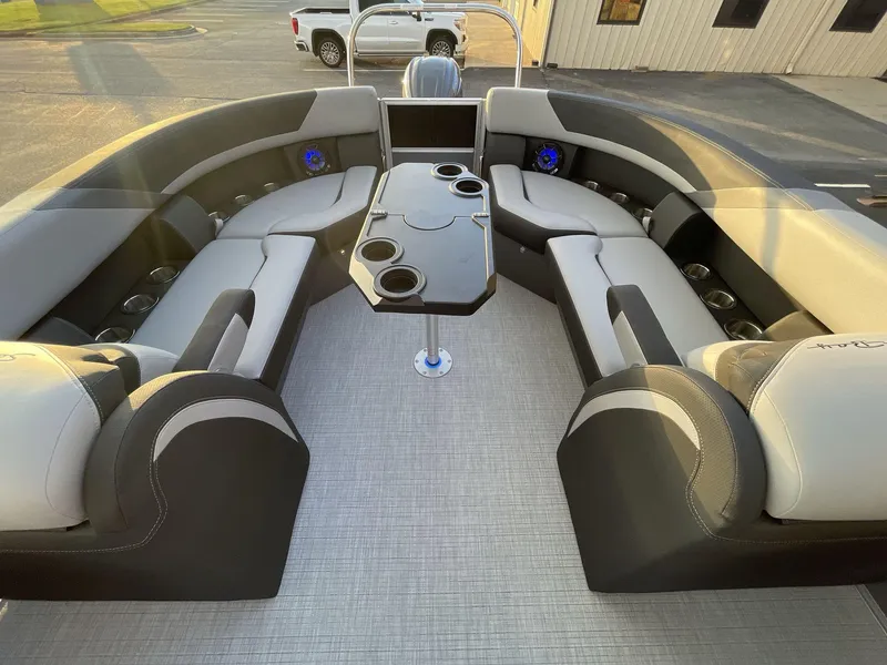 Slide: The Image of Luxurious interior of 2025 South Bay S224RS pontoon boat with plush seating and cup holders. - 12