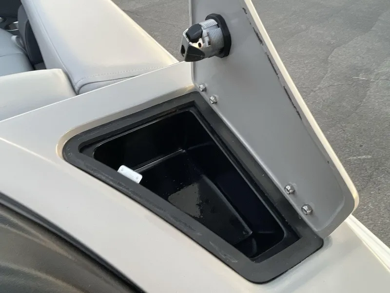 Slide: The Image of Open storage compartment on 2025 South Bay S224RS boat, featuring a sleek design. - 17