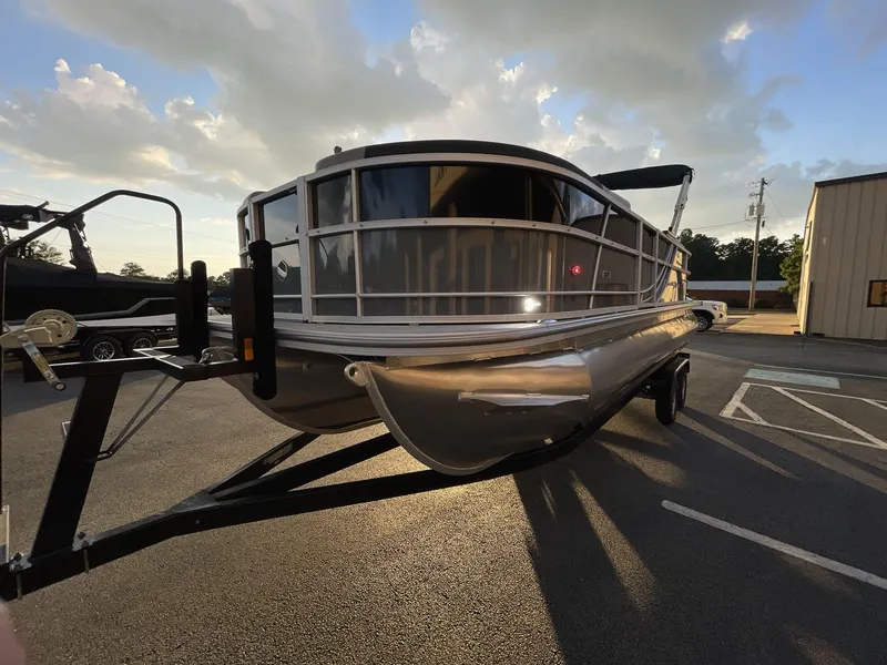 Slide: The Image of 2025 South Bay S224RS pontoon boat on trailer at sunset. - 2