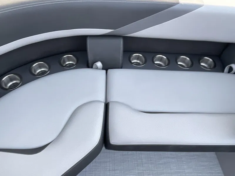 Slide: The Image of 2025 South Bay S224RS boat interior with cushioned seating and multiple cup holders. - 20