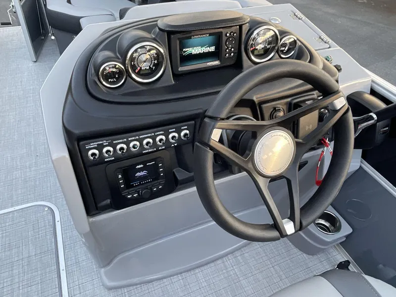 Slide: The Image of 2025 South Bay S224RS boat dashboard with steering wheel and control panel. - 23