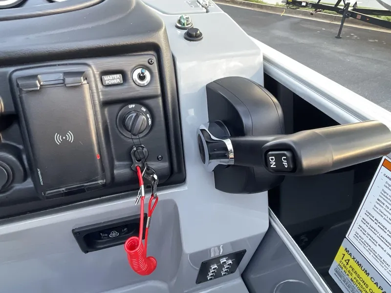 Slide: The Image of Control panel of 2025 South Bay S224RS boat with throttle and ignition switch. - 24
