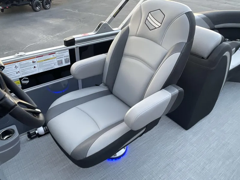 Slide: The Image of Captain's chair in 2025 South Bay S224RS boat, featuring sleek gray upholstery and modern design. - 26