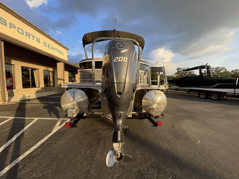 Slide: The Image of 2025 South Bay S224RS pontoon boat with powerful outboard motor at dealership. - 35