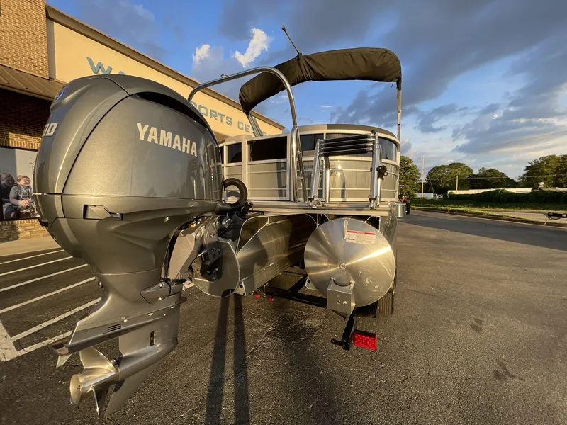Slide: The Image of 2025 South Bay S224RS pontoon boat with Yamaha engine, parked outdoors at sunset. - 36