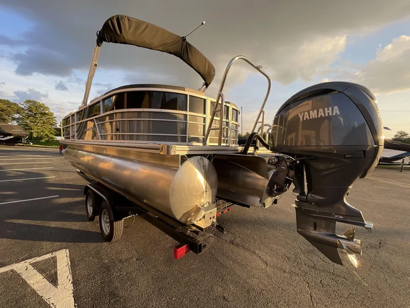 Slide: The Image of 2025 South Bay S224RS pontoon boat with Yamaha outboard motor in a parking lot. - 4