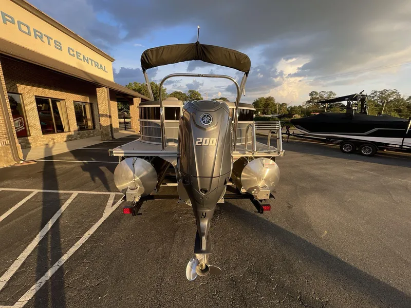 Slide: The Image of 2025 South Bay S224RS pontoon boat with 200 HP engine at dealership parking lot. - 5