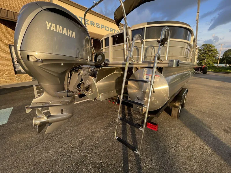 Slide: The Image of 2025 South Bay S224RS pontoon boat with Yamaha outboard motor and ladder, parked outdoors. - 8